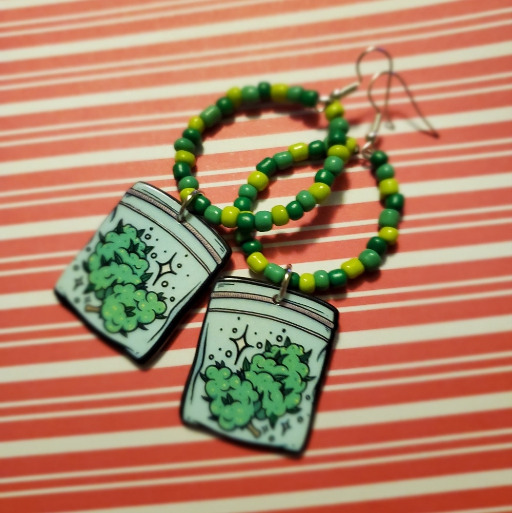 Dangle earrings a couple baggies of flower accented by a green glass bead ring
